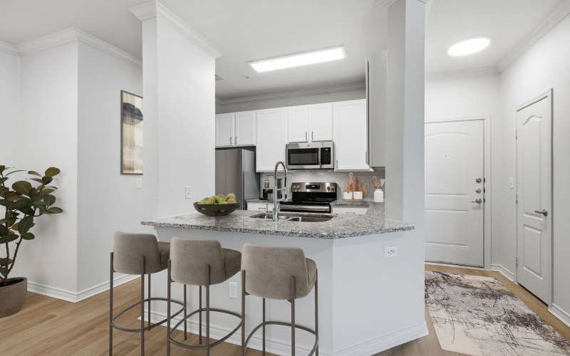 Kitchen and island with barstools