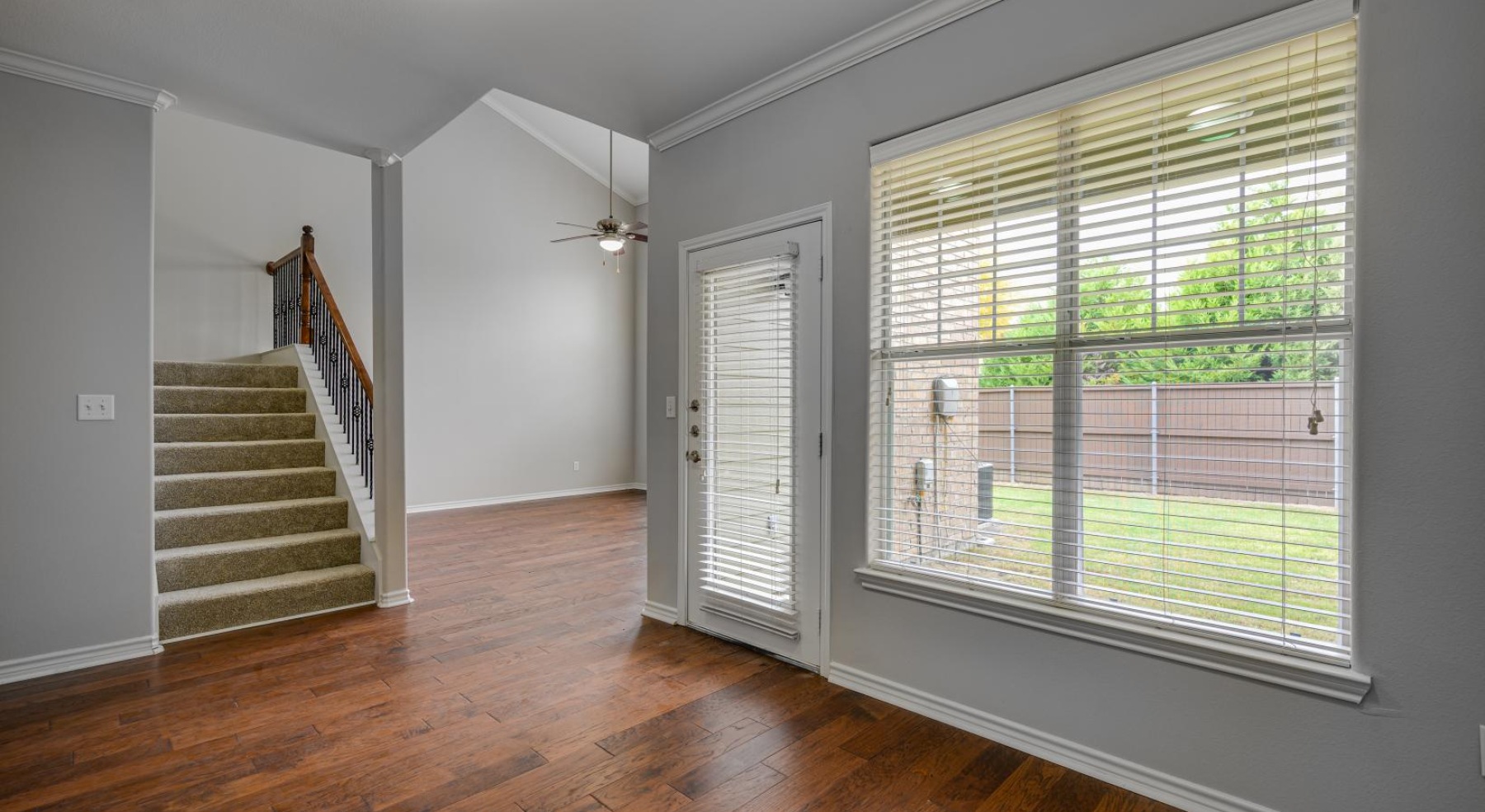 a room with a wood floor and a window