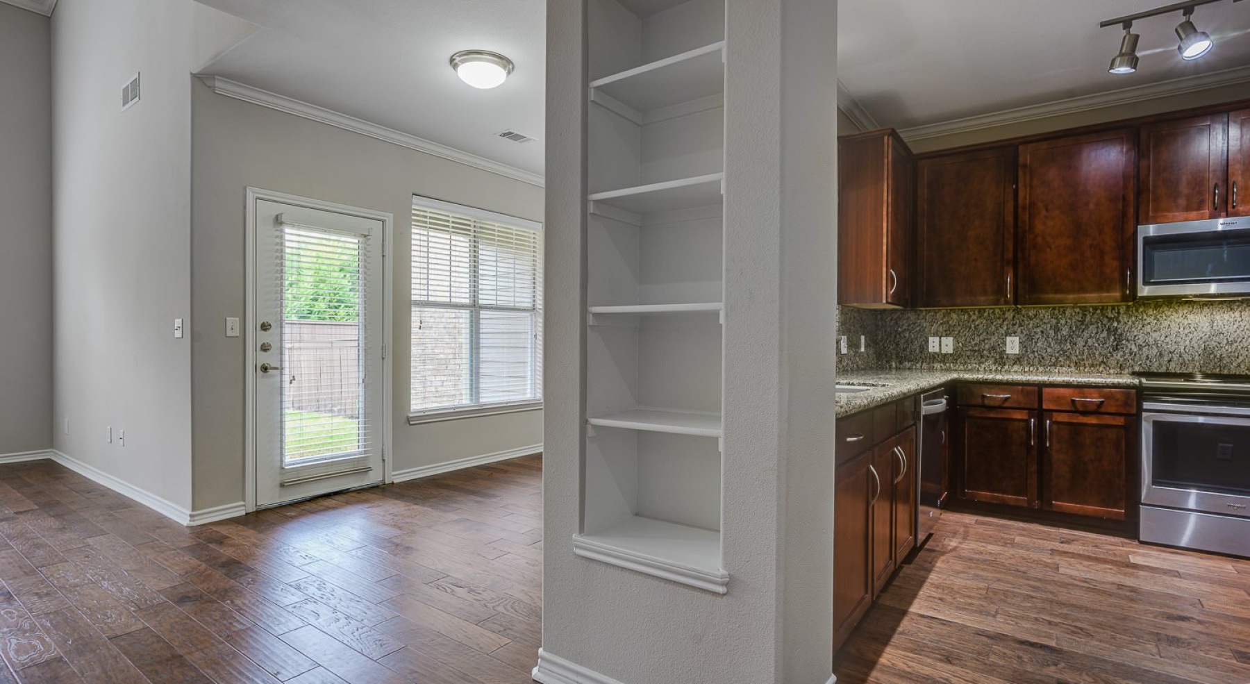 kitchen and living room with shelves