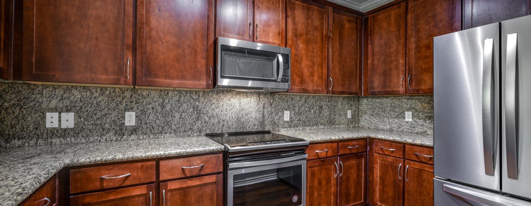 a kitchen with wooden cabinets